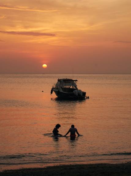 Sunset Bathing in front Boat
